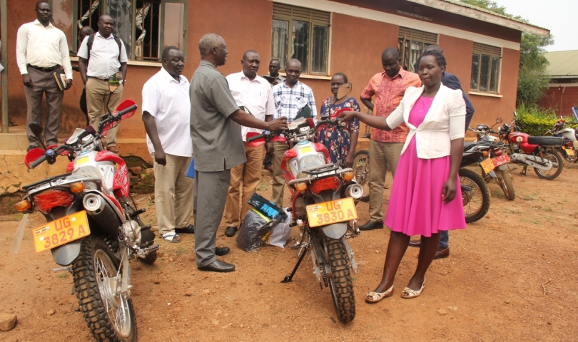 Chief Administrative Officer/Apac, Canon George Adoko hands over the key to Akech Caroline
